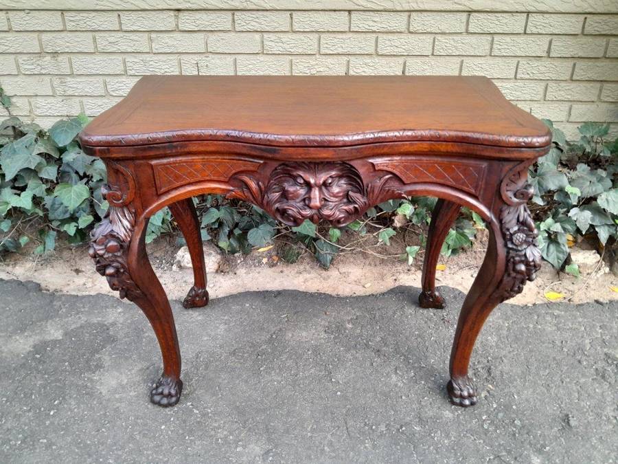 An Antique Jacobean Ornately Carved Oak Card Table with Black Baize