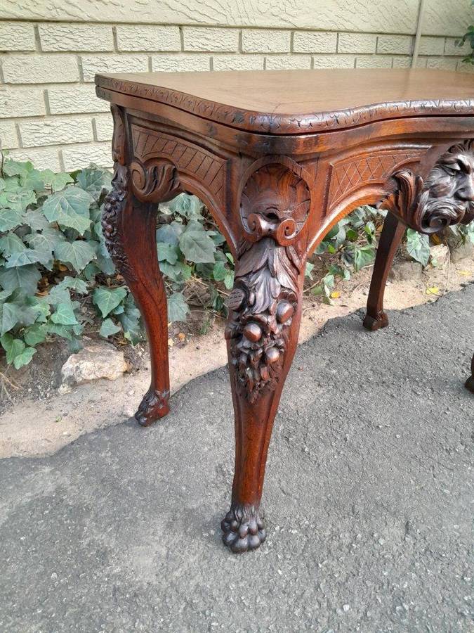 An Antique Jacobean Ornately Carved Oak Card Table with Black Baize