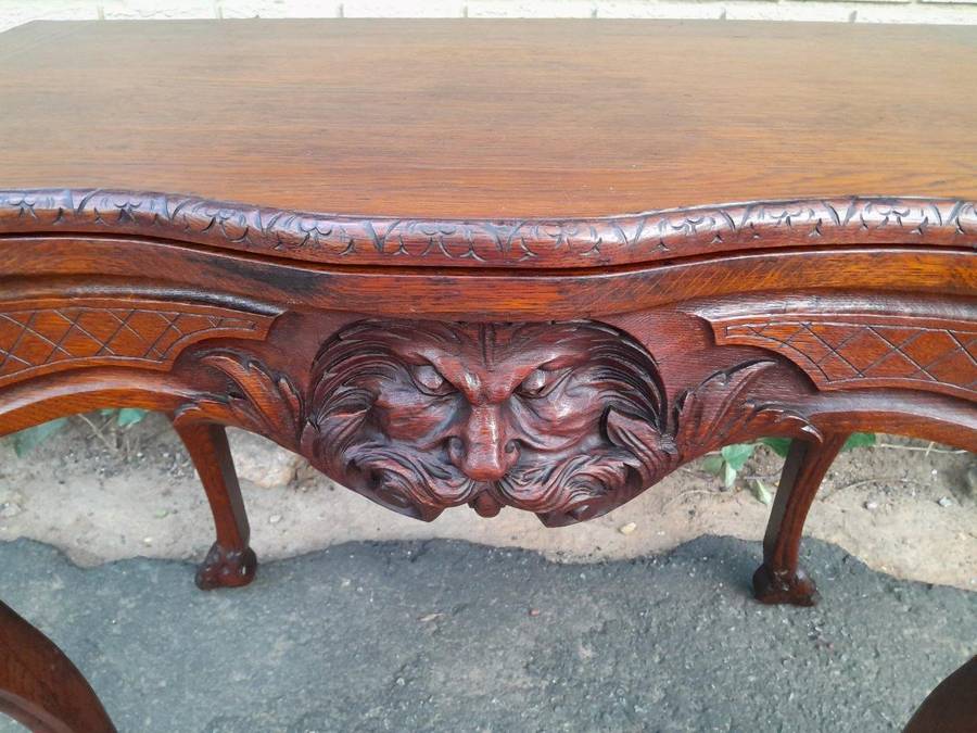 An Antique Jacobean Ornately Carved Oak Card Table with Black Baize