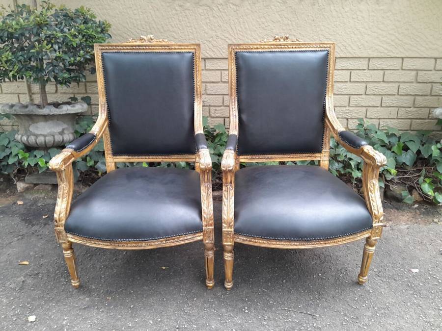 A 20th Century French Style Pair of Carved Gilt-Wood Arm Chairs Upholstered in Black Leather