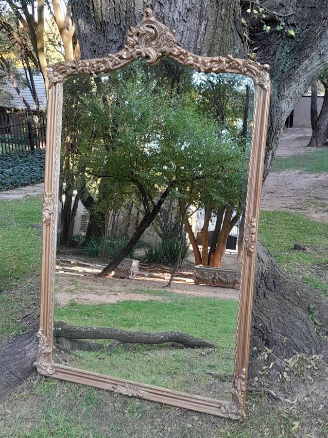 A French Style Ornately Carved and Gilded Bevelled Mirror of Large Proportions