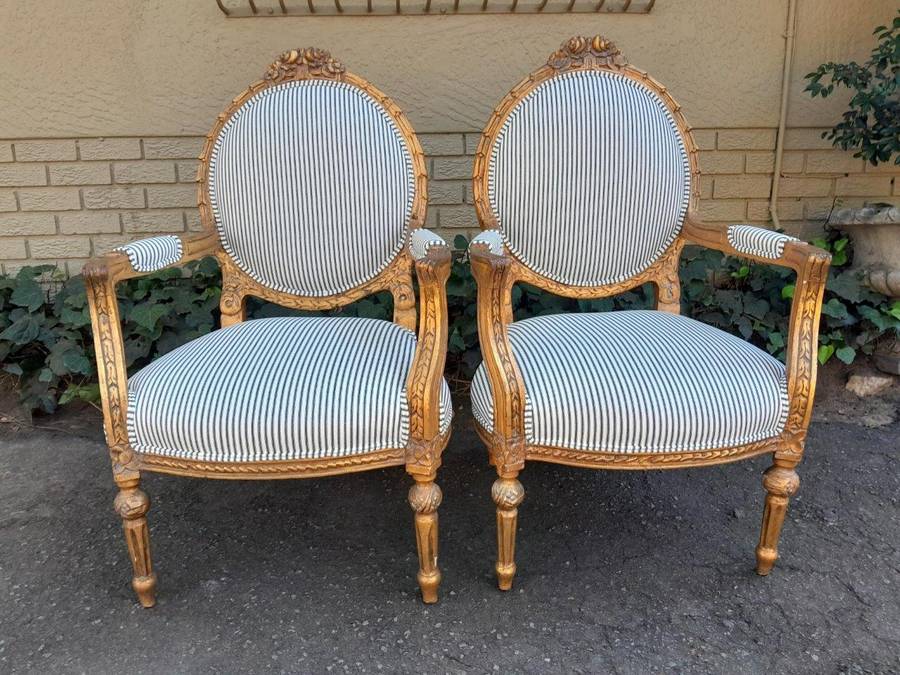 A 20TH Century French Style Pair Of Ornately Carved Giltwood Armchairs