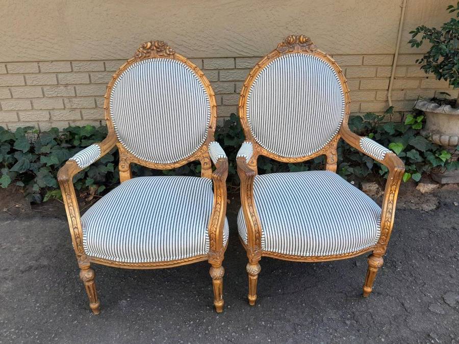 A 20TH Century French Style Pair Of Ornately Carved Giltwood Armchairs