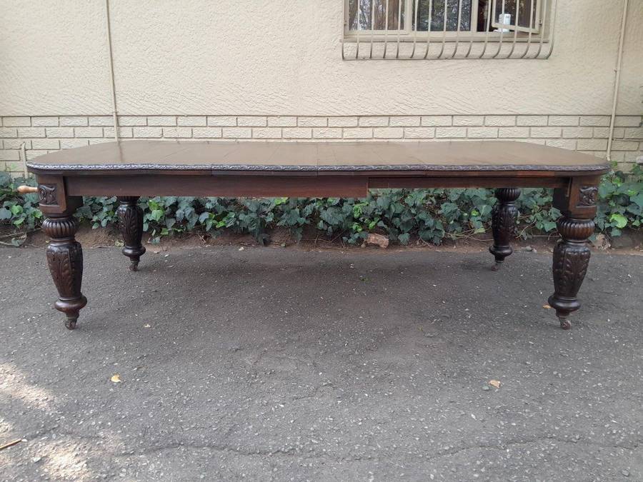 An Antique Victorian English Carved Oak Extending Dining Table on Castors and with Crank Handle (...