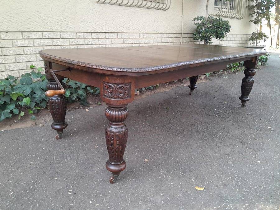 An Antique Victorian English Carved Oak Extending Dining Table on Castors and with Crank Handle (...