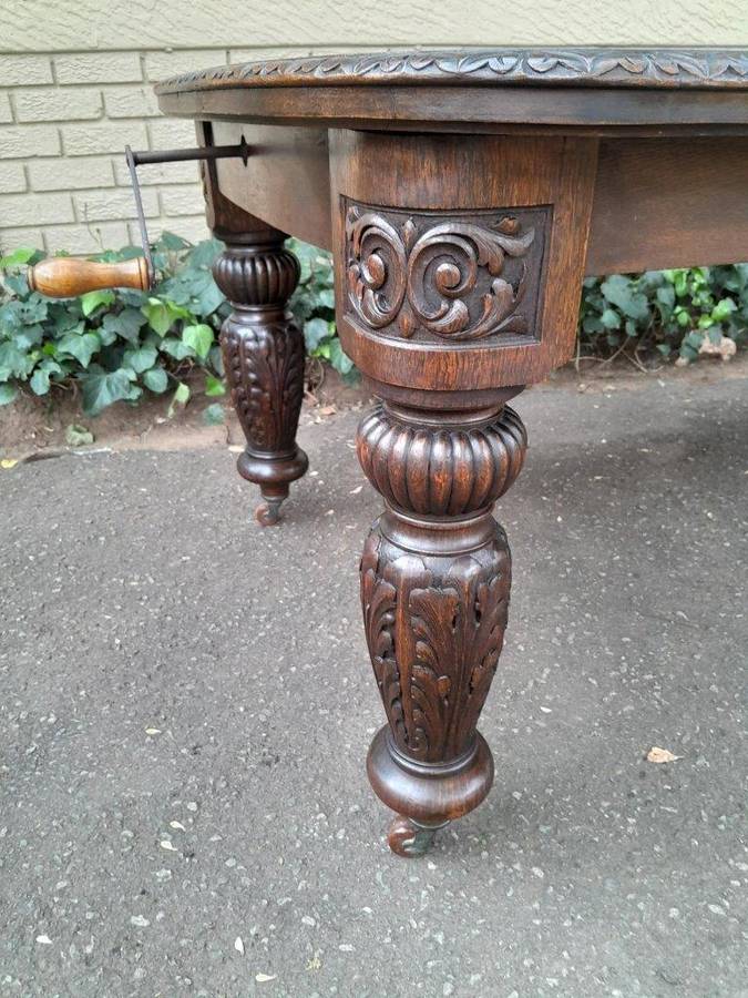 An Antique Victorian English Carved Oak Extending Dining Table on Castors and with Crank Handle (...