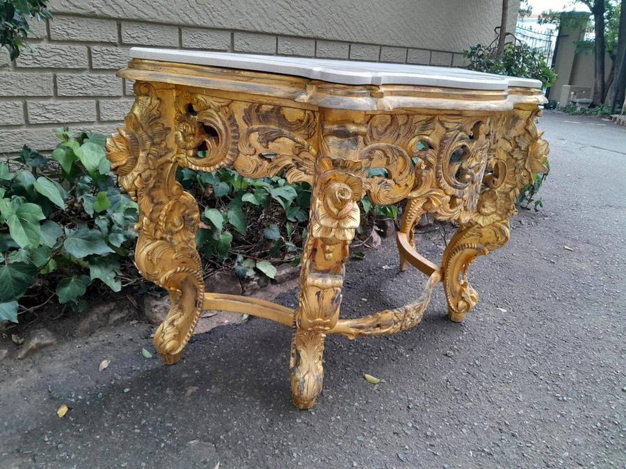 A 20th Century Heavily Carved and Hand Gilded with Gold Leaf Console Table with Cream Marble Top