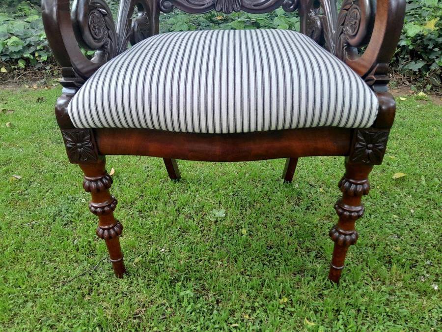 An Antique Mahogany Heavily Carved Armchair Upholstered Nd