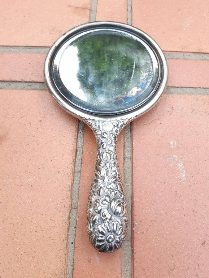 An Antique Repoussé Sterling Silver Hand Held Mirror with signed initials "HDD"
