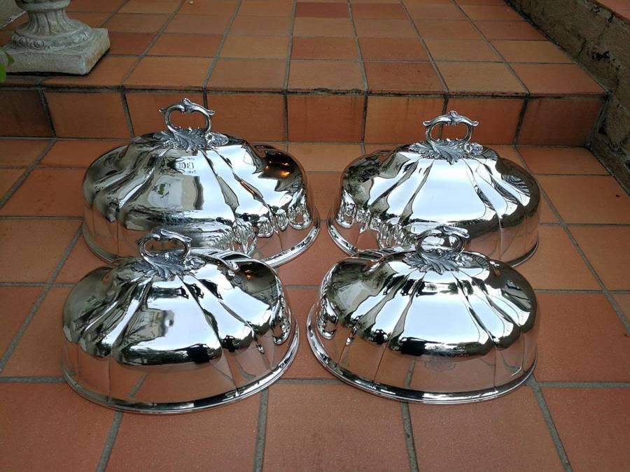 A Set Of Four Silver-Plate Food Domes