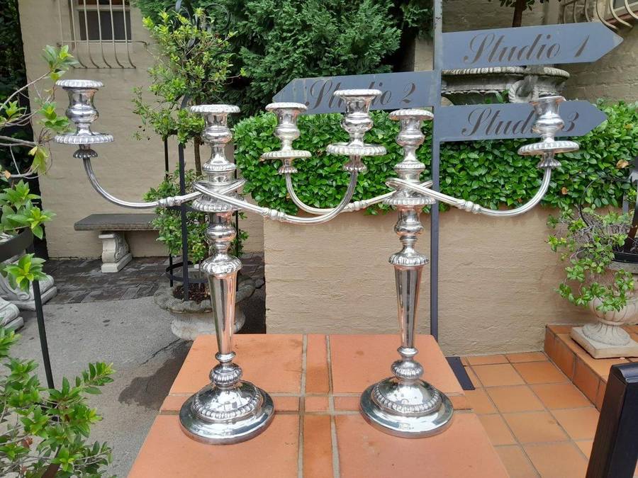 A 20TH Century Pair of Silver Plated Embossed Candelabra