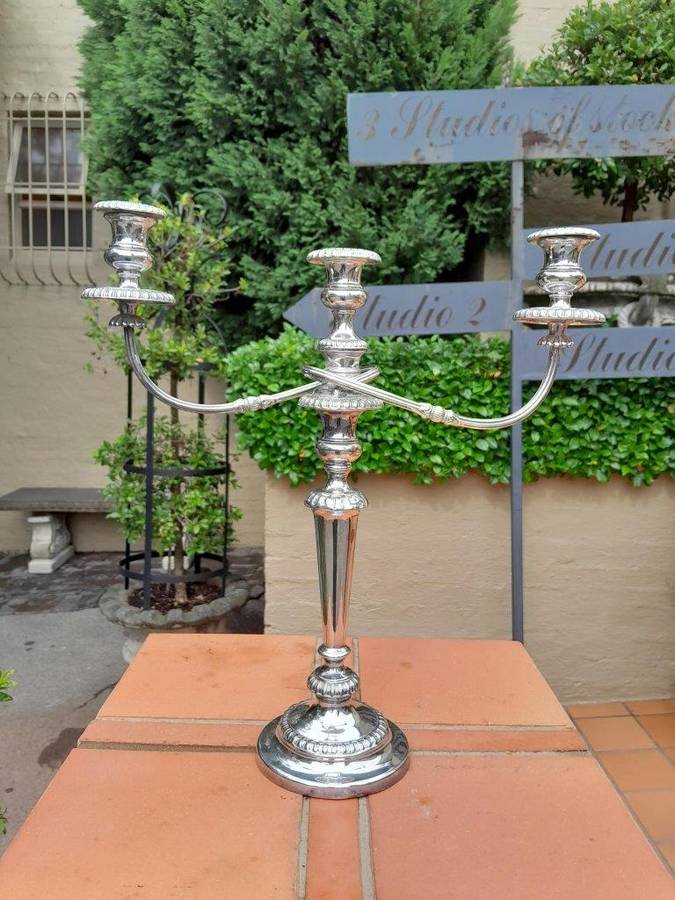 A 20TH Century Pair of Silver Plated Embossed Candelabra