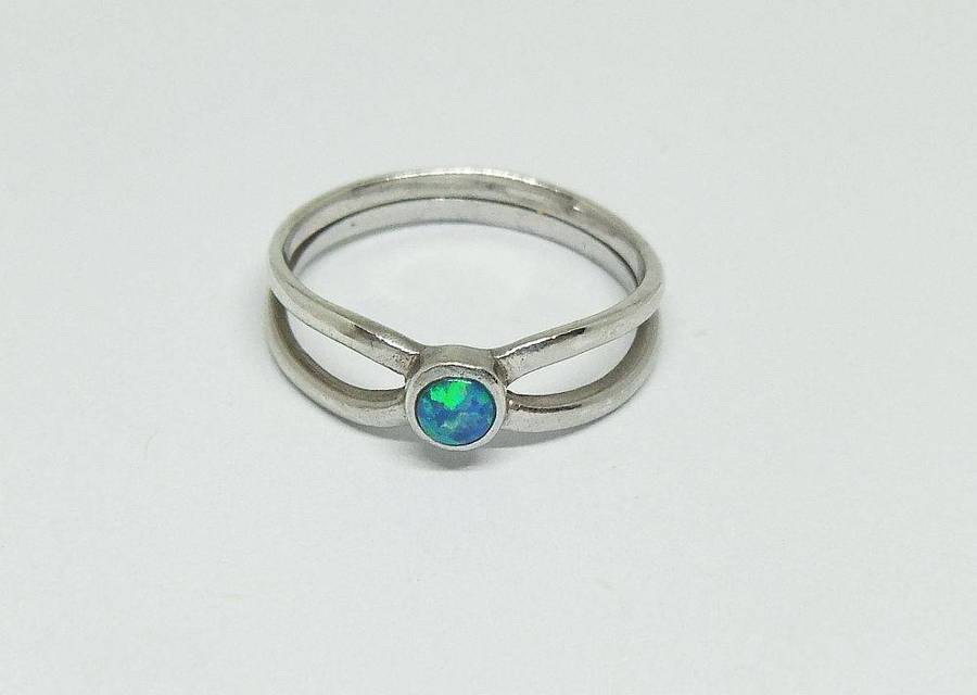 A charming sterling silver ring with a cabochon fiery Opal inset