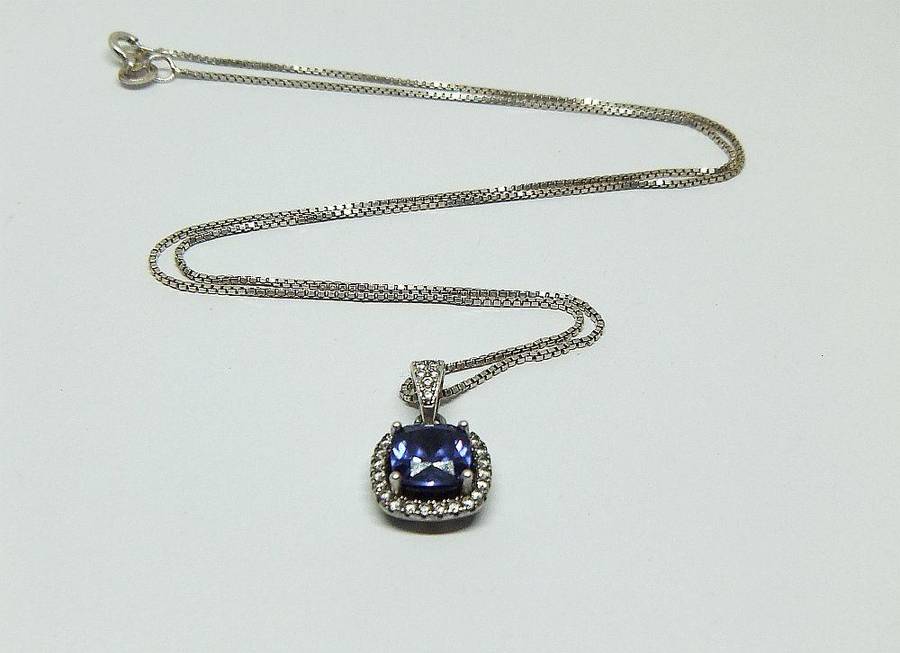 Sterling silver pendant with faceted blue inset and necklace