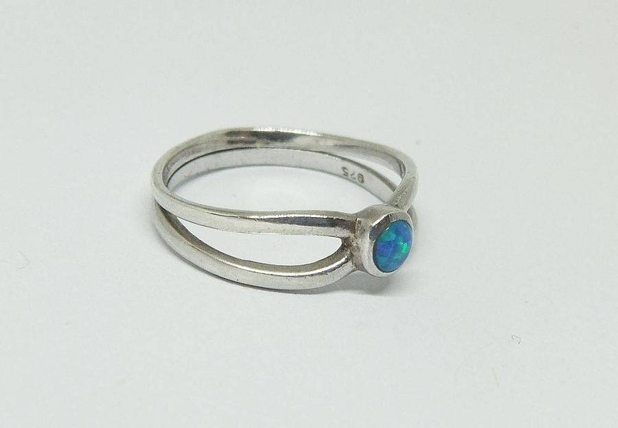 A charming sterling silver ring with a cabochon fiery Opal inset