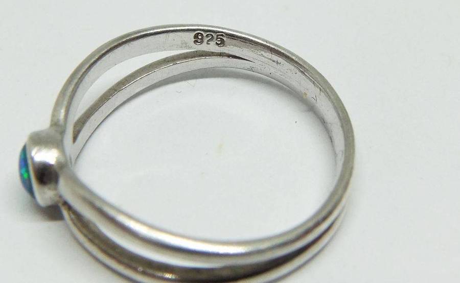 A charming sterling silver ring with a cabochon fiery Opal inset