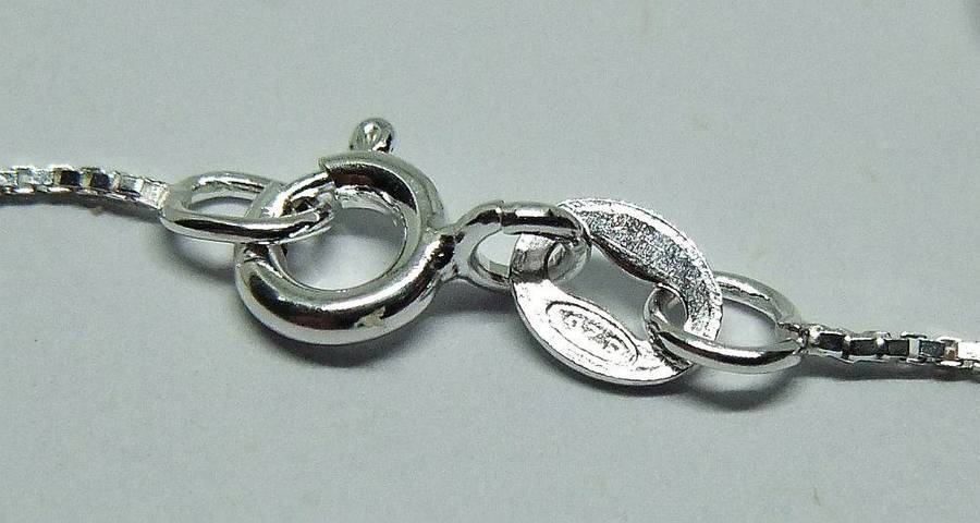 A vintage sterling silver Libra Zodiac sign pendant with a sterling silver necklace