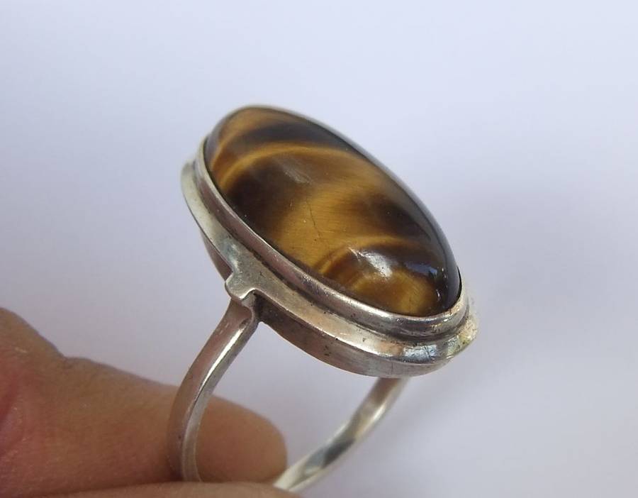 AN ART DECO STYLE VINTAGE STERLING SILVER RING SET WITH A CABOCHON GENUINE TIGERS EYE STONE