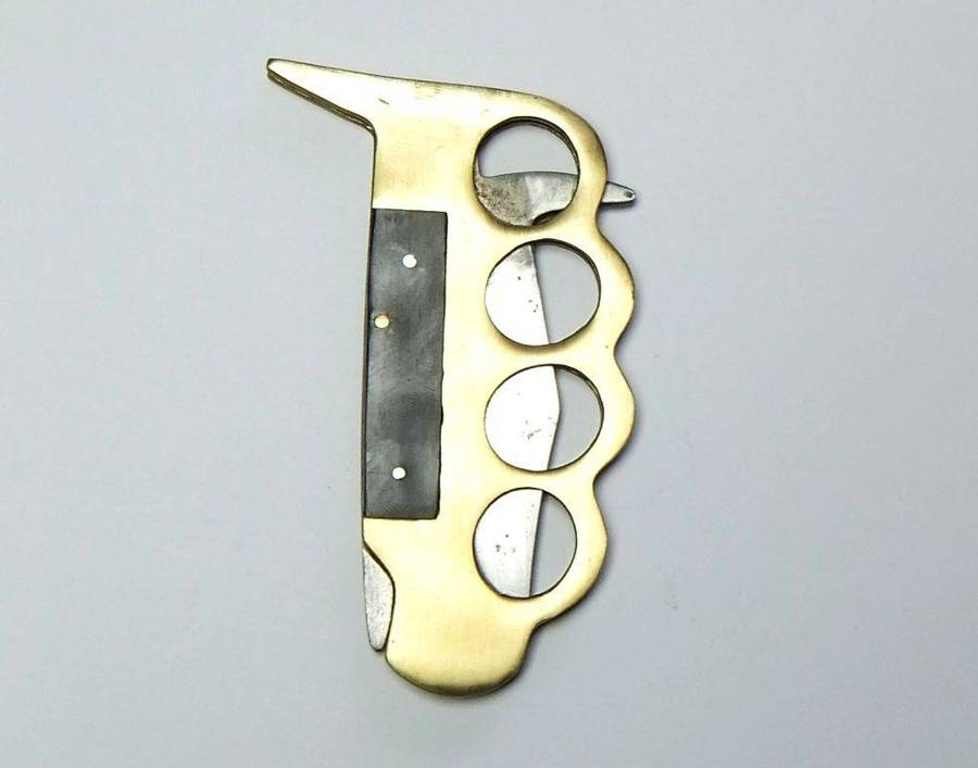 A rarely seen vintage brass knuckle duster knife combo in great working condition