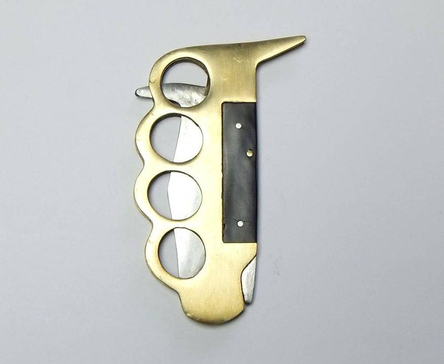 A rarely seen vintage brass knuckle duster knife combo in great working condition