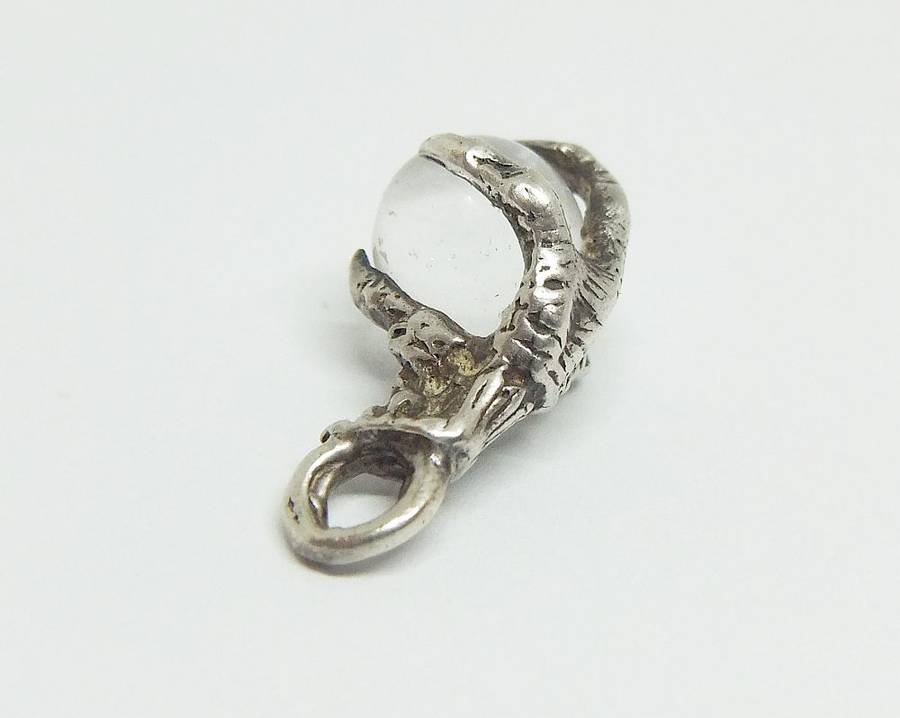 AN OLD LOOKING STERLING SILVER PENDANT OR CHARM MODELED AS AN EAGLES CLAW HOLDING A GLASS ORB !!