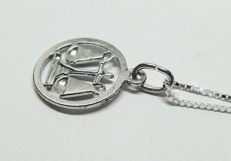 A vintage German 835 silver Libra Zodiac sign pendant with a sterling silver necklace