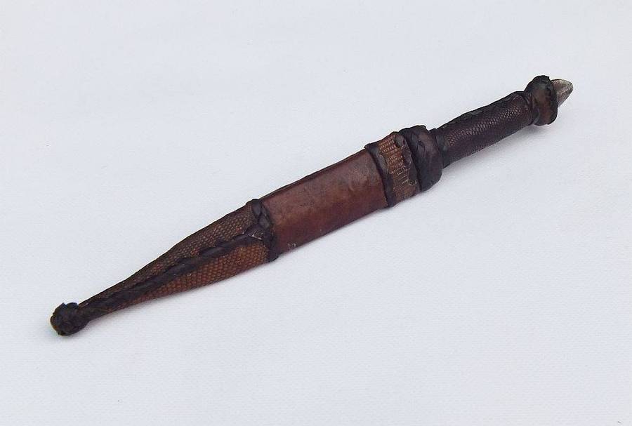 A rare antique North African Tuareg tribal dagger with leather sheath and handle