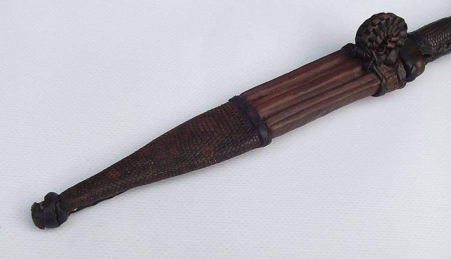 A rare antique North African Tuareg tribal dagger with leather sheath and handle