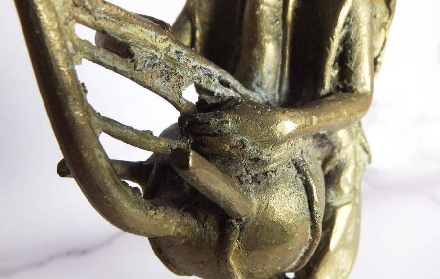 A rare mid 20th century African solid bronze statue of a tribesman with a traditional instrument
