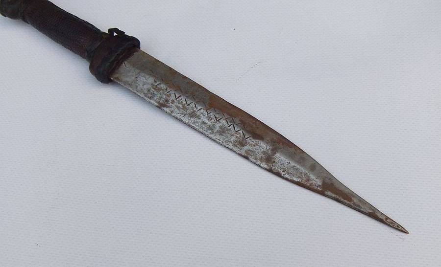 A rare antique North African Tuareg tribal dagger with leather sheath and handle