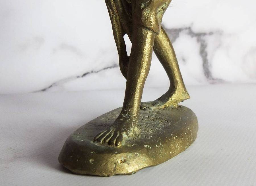 A rare mid 20th century African solid bronze statue of a tribesman with a traditional instrument