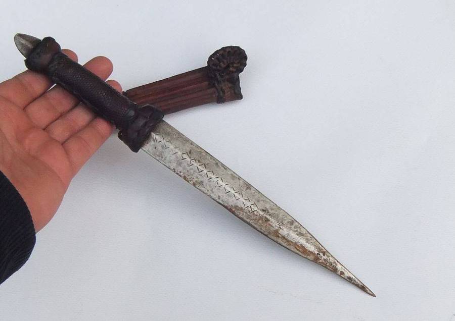 A rare antique North African Tuareg tribal dagger with leather sheath and handle