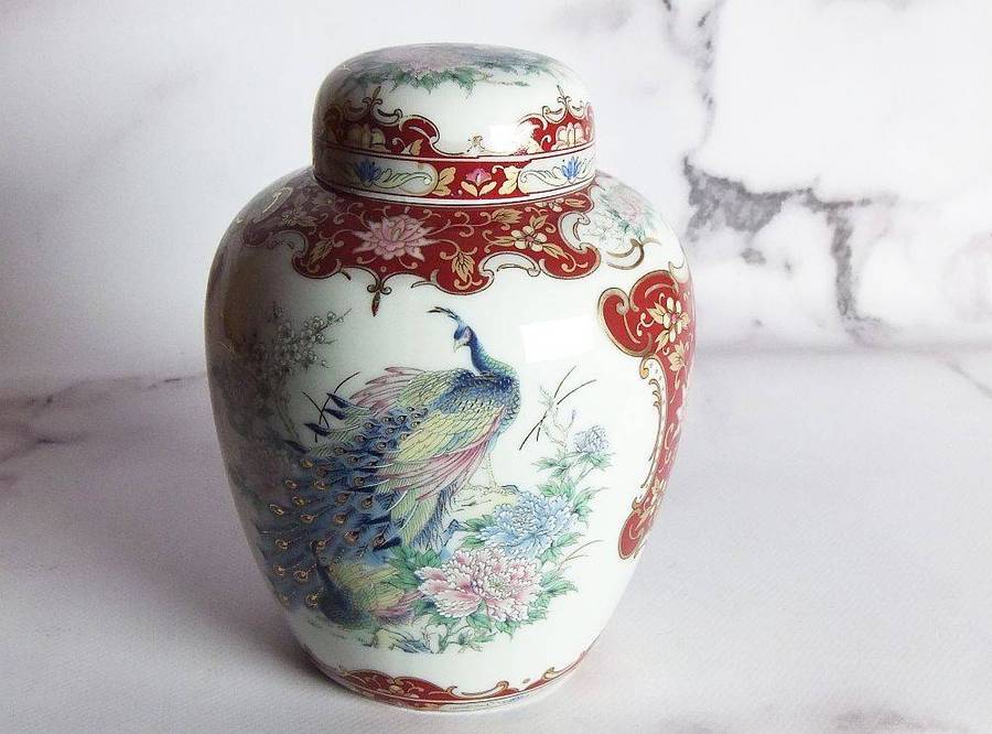 A vintage Oriental porcelain ginger jar with Peacock motif and gold detail