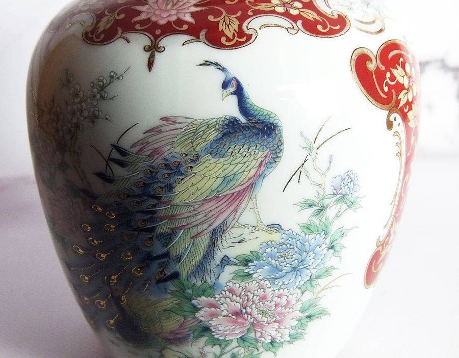 A vintage Oriental porcelain ginger jar with Peacock motif and gold detail