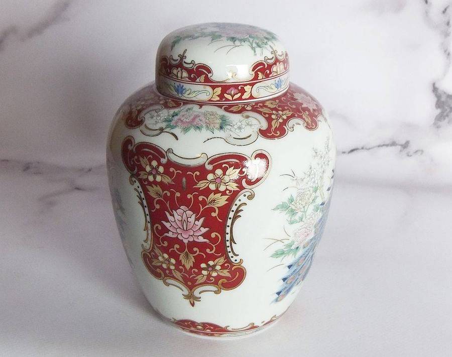 A vintage Oriental porcelain ginger jar with Peacock motif and gold detail
