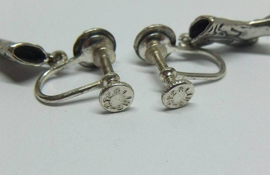 A unique pair of vintage sterling silver earrings with cabochon Turquoise and cowgirl booties