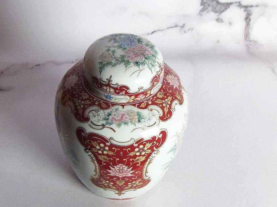 A vintage Oriental porcelain ginger jar with Peacock motif and gold detail