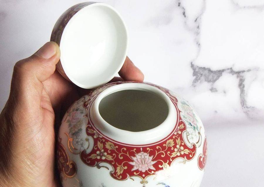 A vintage Oriental porcelain ginger jar with Peacock motif and gold detail