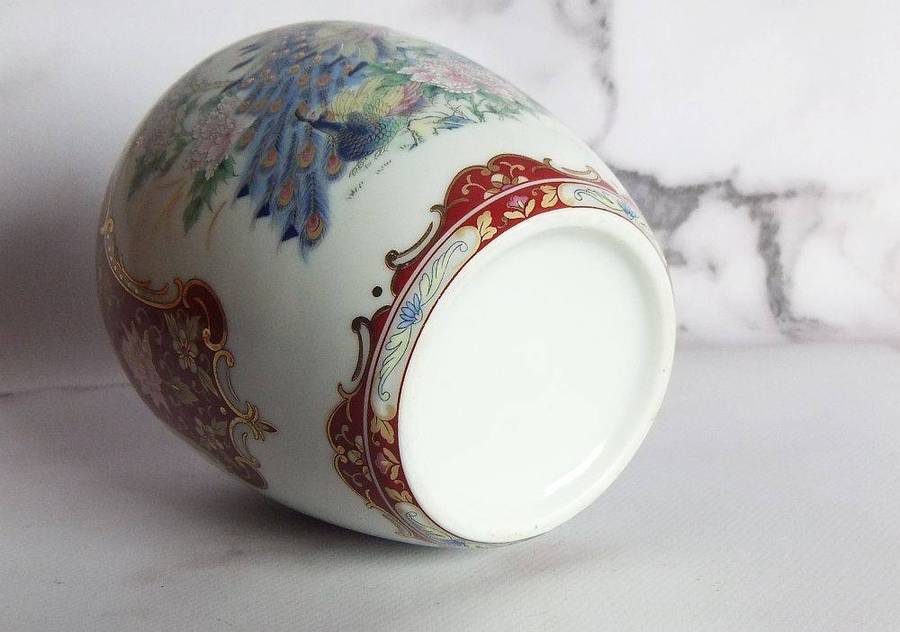 A vintage Oriental porcelain ginger jar with Peacock motif and gold detail