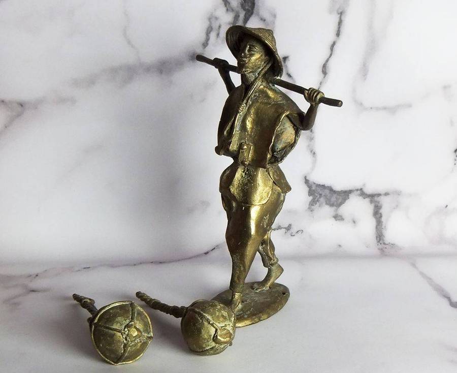 A rare mid 20th century African solid bronze statue of a water carrier