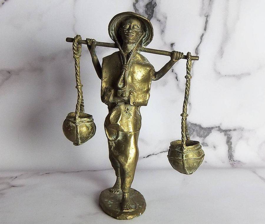 A rare mid 20th century African solid bronze statue of a water carrier
