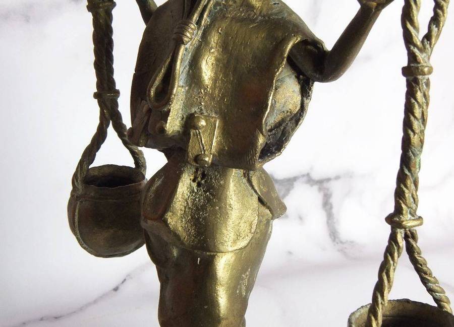 A rare mid 20th century African solid bronze statue of a water carrier