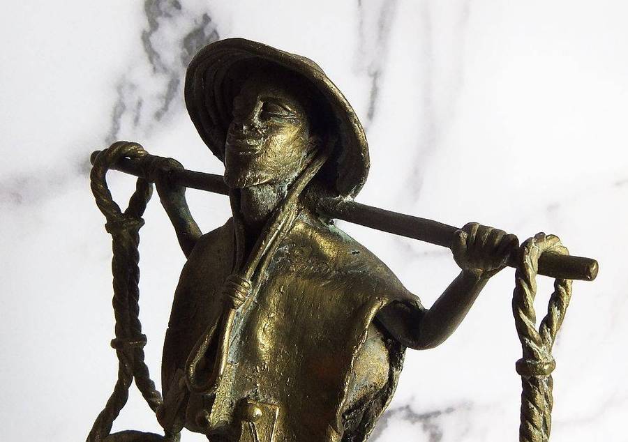 A rare mid 20th century African solid bronze statue of a water carrier