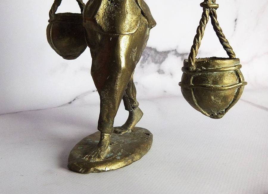 A rare mid 20th century African solid bronze statue of a water carrier