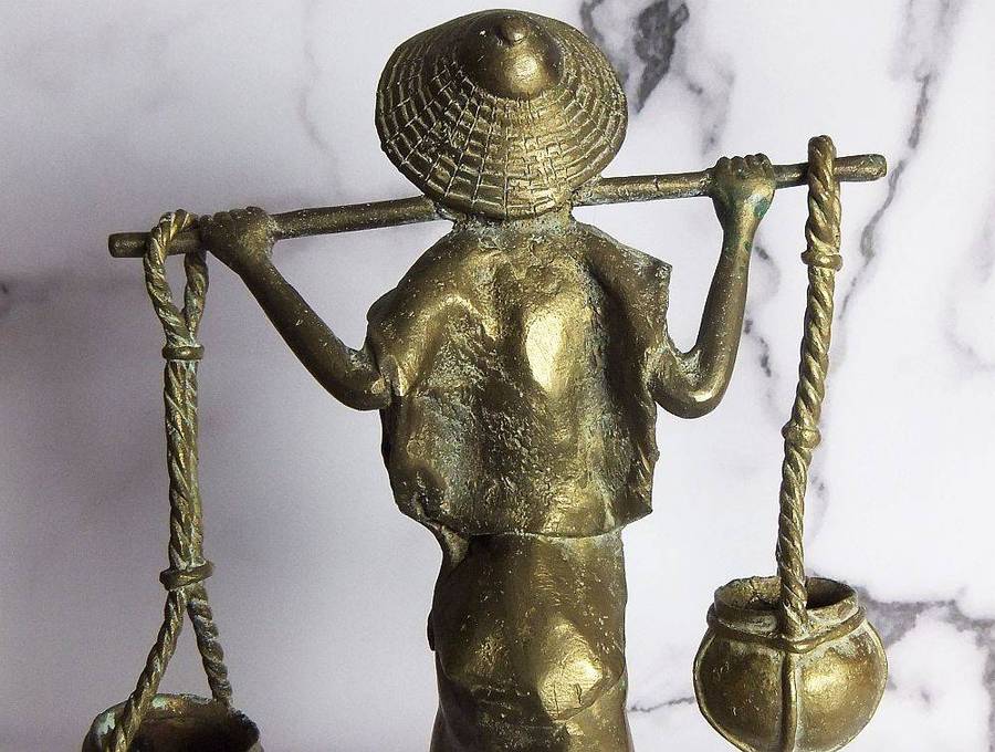 A rare mid 20th century African solid bronze statue of a water carrier