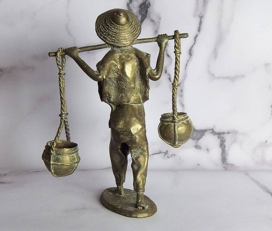 A rare mid 20th century African solid bronze statue of a water carrier