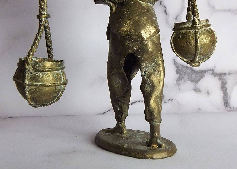 A rare mid 20th century African solid bronze statue of a water carrier