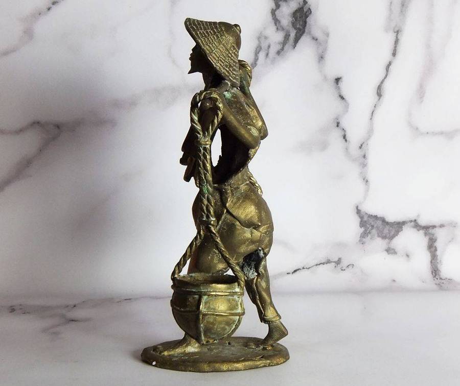 A rare mid 20th century African solid bronze statue of a water carrier