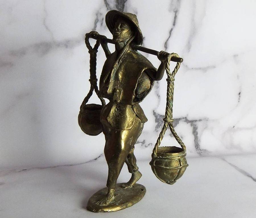A rare mid 20th century African solid bronze statue of a water carrier