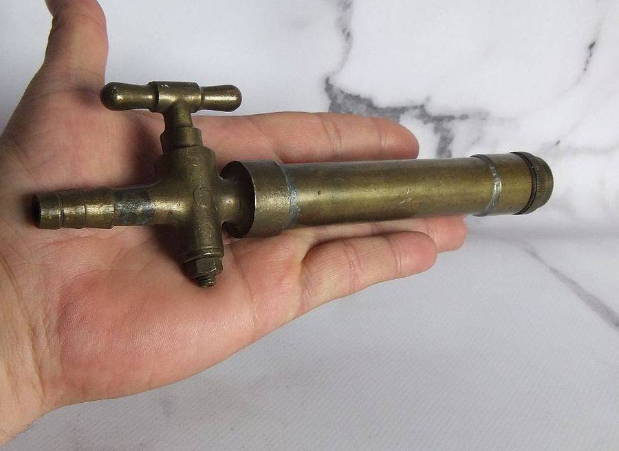 An old solid bronze or brass tap most likely alcohol related
